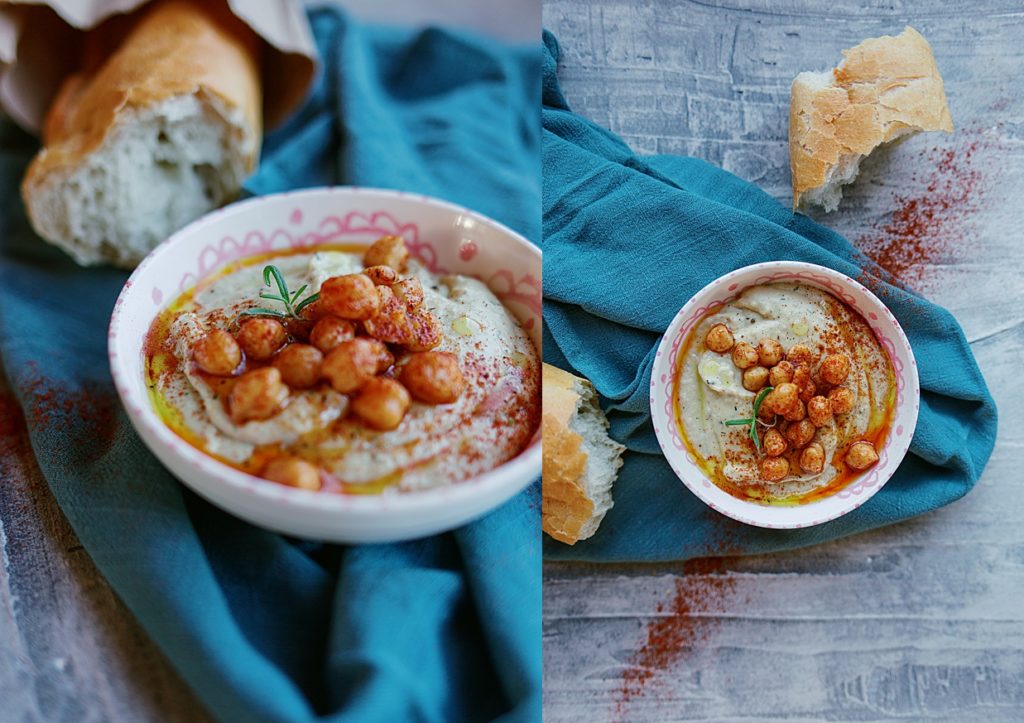 Two views of a lemon and dill hummus generously topped with Olive Oil, paprika, and marinated chickpeas, on a blue towel.